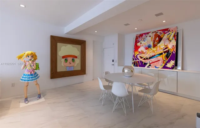 a living room with furniture and a wall painting