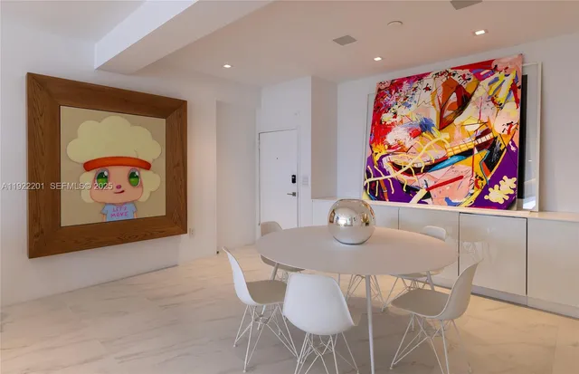 a view of a dining room with furniture and a kitchen
