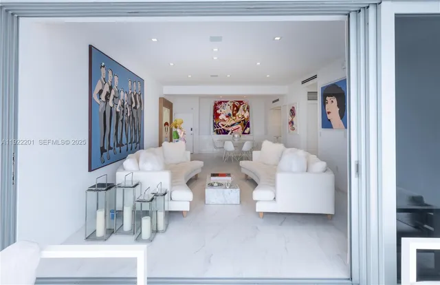 a living room with furniture and painting on the wall