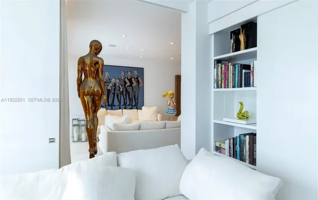 a living room with furniture and a book shelf