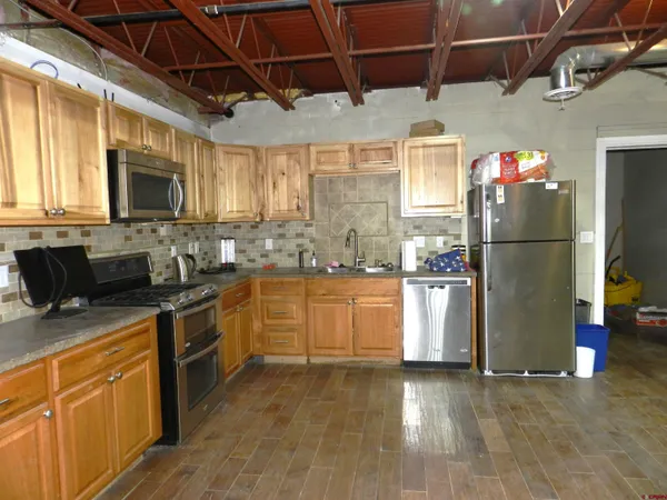 a view of a room with wooden floor