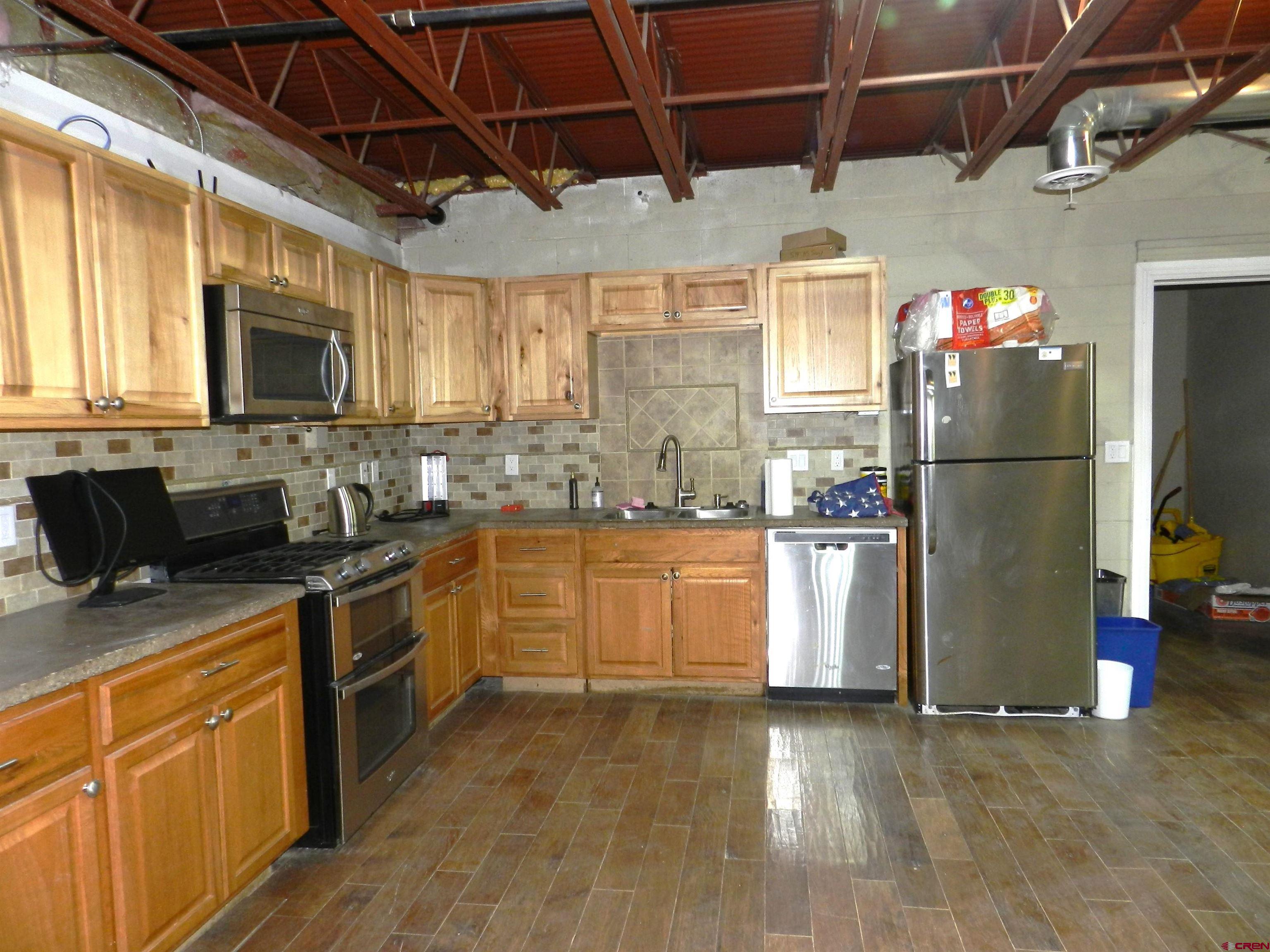 2520 North River Road Olathe, CO 81425 - Photo 29 of 35 a kitchen with refrigerator and cabinets