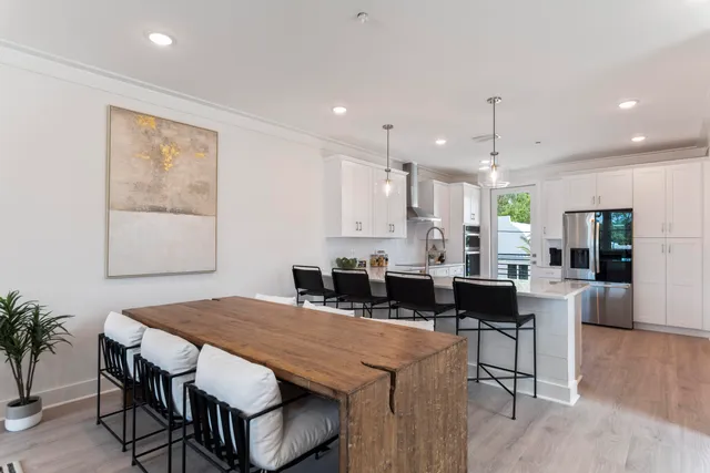 a kitchen with stainless steel appliances a refrigerator sink and cabinets
