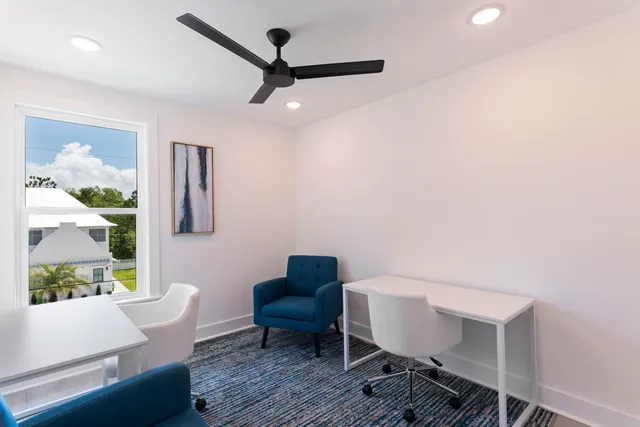 a living room with furniture and a ceiling fan