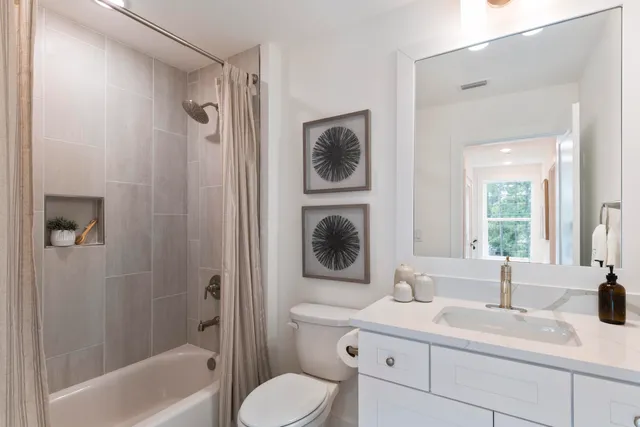 a bedroom with two large bed and a window