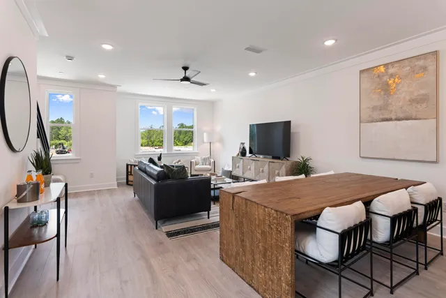 a living room with furniture a window and wooden floor