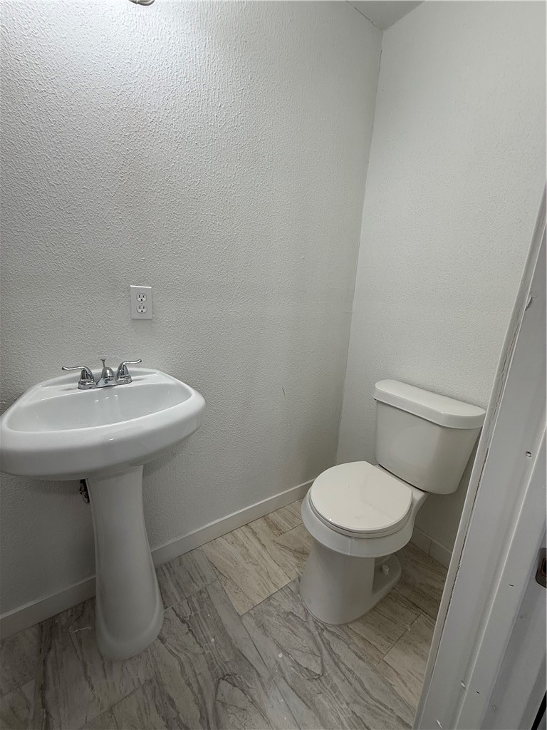 3001 Ruth Street Corpus Christi, TX 78405 - Photo 20 of 27 a bathroom with a sink toilet and a mirror