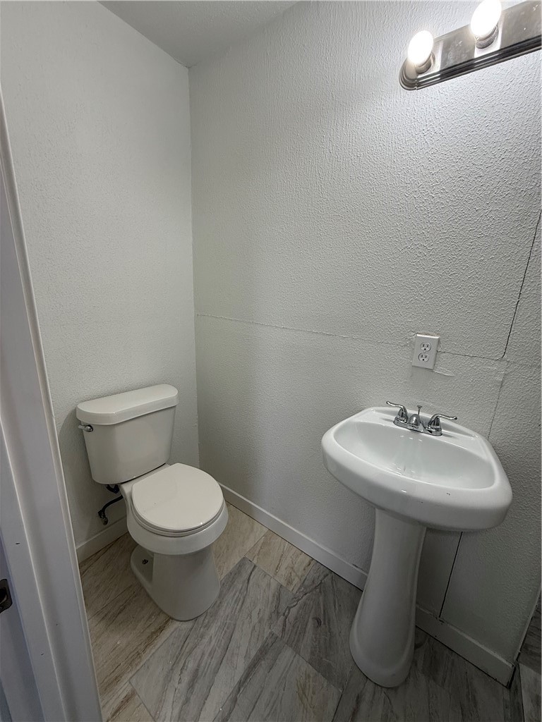 3001 Ruth Street Corpus Christi, TX 78405 - Photo 24 of 27 a bathroom with a sink toilet and a mirror