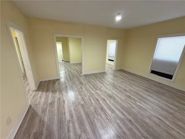 a view of an empty room and wooden floor