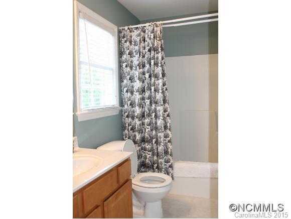 223 General Griffith Circle Rutherfordton, NC 28139 - Photo 20 of 24 a bathroom with a toilet and a shower curtain