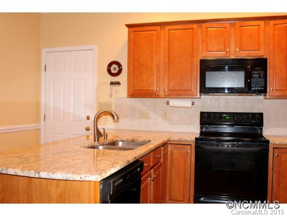 223 General Griffith Circle Rutherfordton, NC 28139 - Photo 9 of 24 a kitchen with granite countertop a sink stainless steel appliances and cabinets