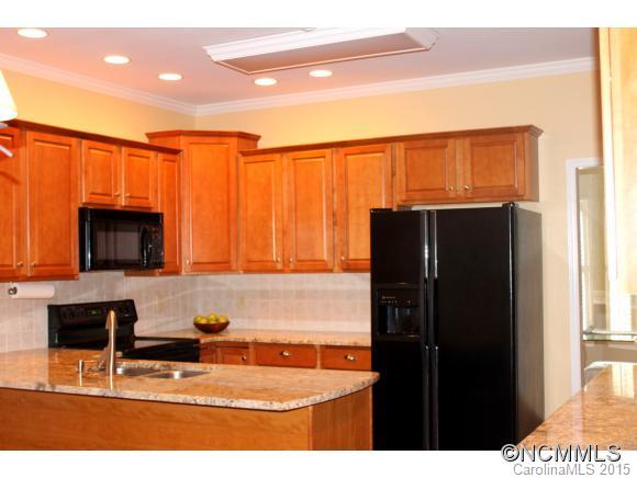 223 General Griffith Circle Rutherfordton, NC 28139 - Photo 10 of 24 a kitchen with stainless steel appliances kitchen island granite countertop a refrigerator and a microwave