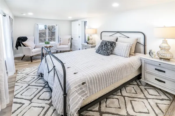 a bedroom with a bed and wooden floor