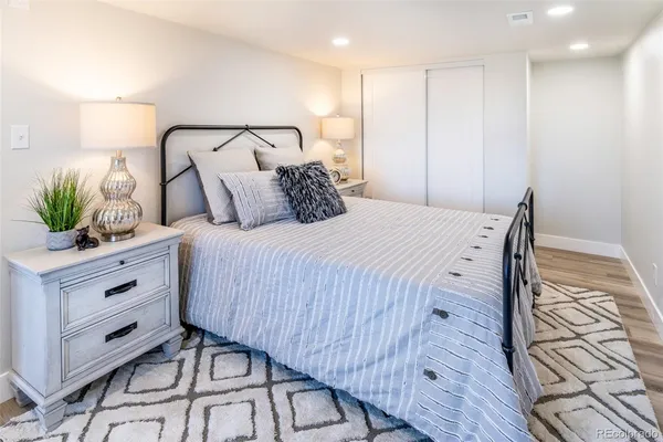 a bedroom with a bed and a potted plant
