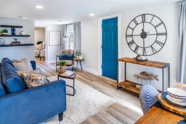 a living room with furniture and a wooden floor