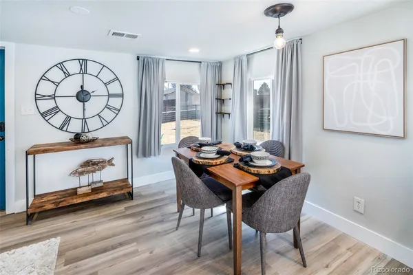 a view of a dining room with furniture window and wooden floor