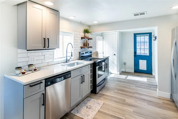 a kitchen with a sink stove and cabinets