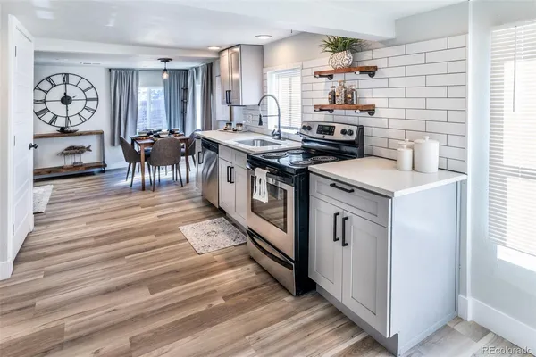 a kitchen with stainless steel appliances granite countertop a stove and a refrigerator