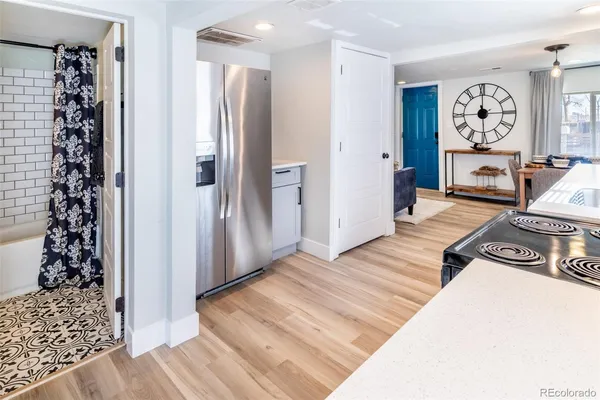 a view of a hallway with wooden floor and workspace