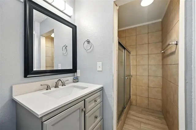 a bathroom with a sink vanity and a mirror