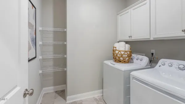 a view of storage and utility room with washer and dryer