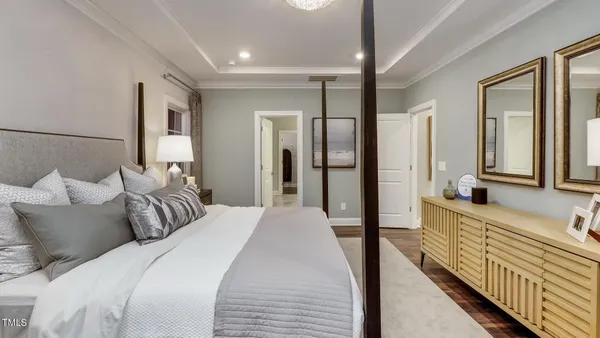 a spacious bedroom with a bed and a large mirror