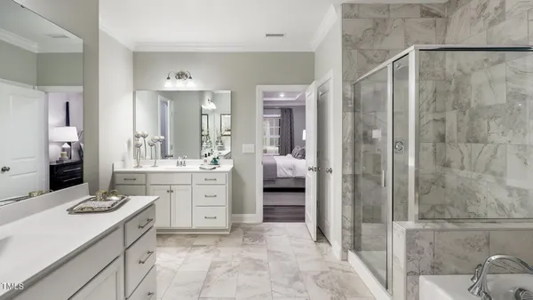 a spacious bathroom with a shower sink and mirror