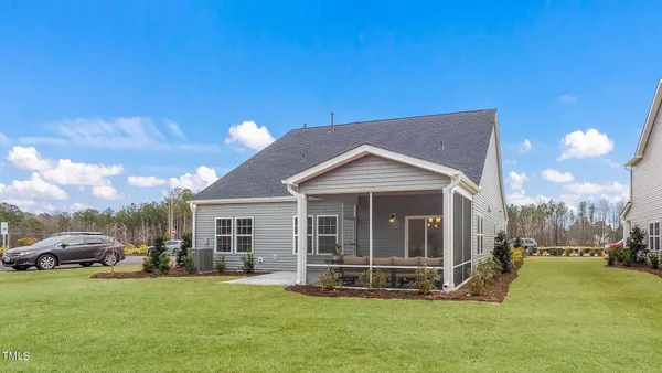 a view of a house with a yard and sitting area