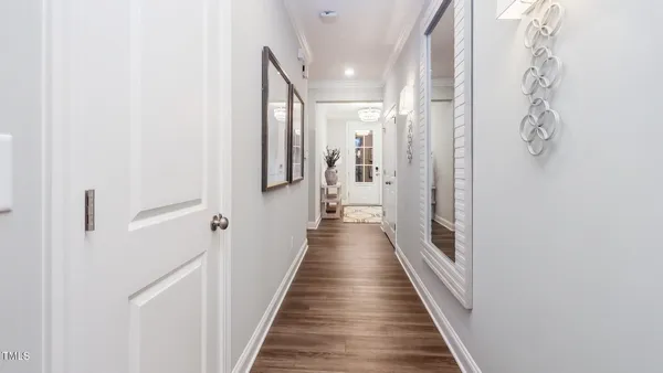a view of a hallway with wooden floor and staircase