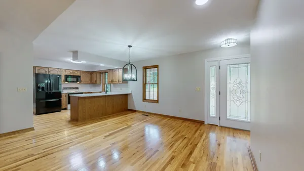 a view of a room with wooden floor and bathroom