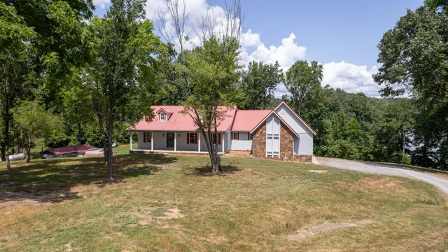 an aerial view of residential house with outdoor space and lake view