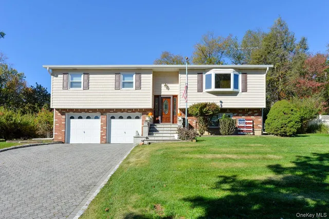 a front view of a house with a garden and yard