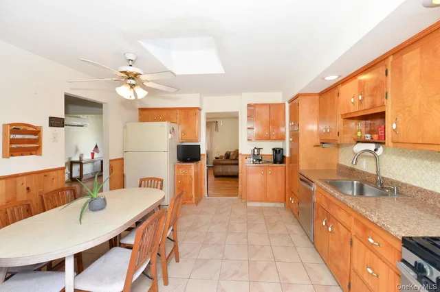 a large kitchen with kitchen island a large counter space and stainless steel appliances