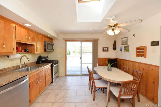 a kitchen with a table chairs sink and stove