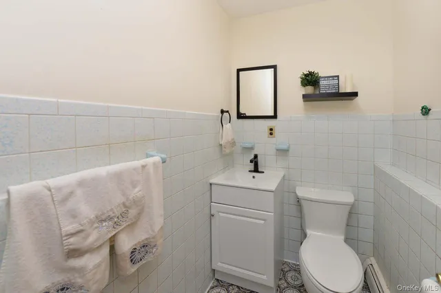 a white toilet sitting next to a bathroom sink