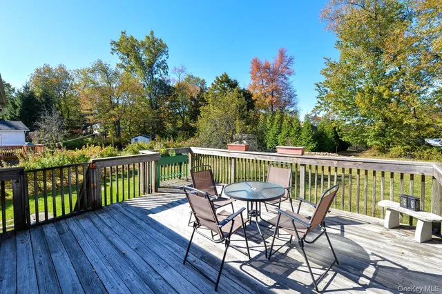 a view of a chair and table on the deck