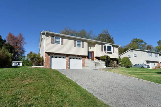 a front view of a house with a garden and yard