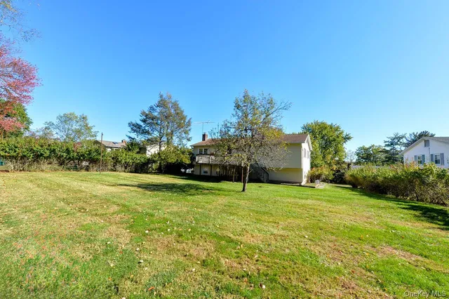 a view of a field of grass and trees