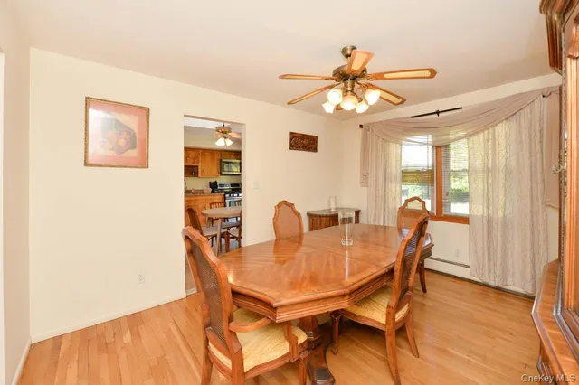 a view of a dining room with furniture and a chandelier