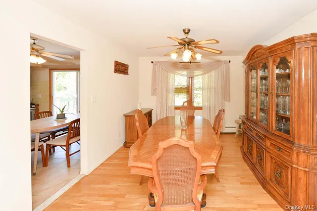 a view of a dining room with furniture and a chandelier