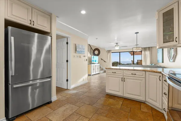 a kitchen with stainless steel appliances a refrigerator sink and cabinets