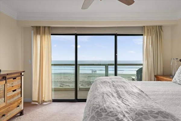 a bedroom with a bed and a large window