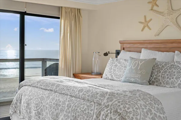 a large bed sitting in a bedroom next to a window