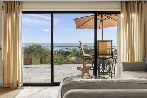 a bedroom with a bed and glass window