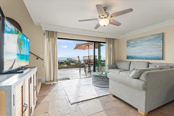 a living room with furniture a large window with a flat screen tv