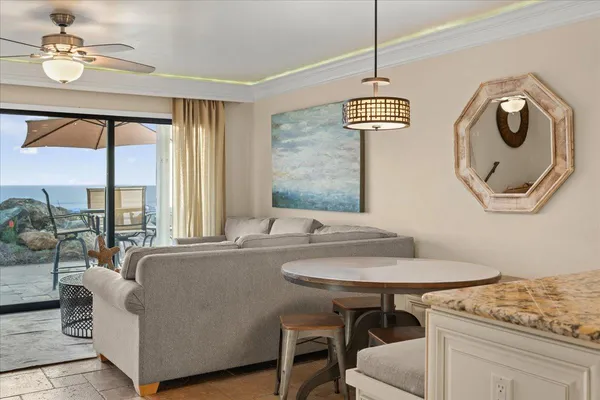 a living room with furniture and a chandelier