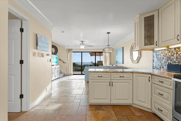 a view of a kitchen with cabinets appliances and a window