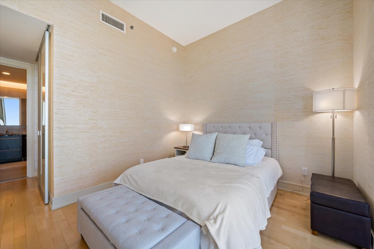 401 North Wabash Avenue, Unit 71C Chicago, IL 60611 - Photo 11 of 38 a bedroom with a bed and a couch