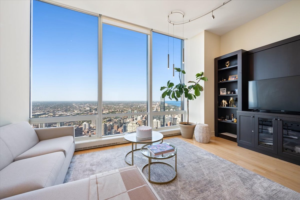 401 North Wabash Avenue, Unit 71C Chicago, IL 60611 - Photo 2 of 38 a living room with furniture a rug and a flat screen tv