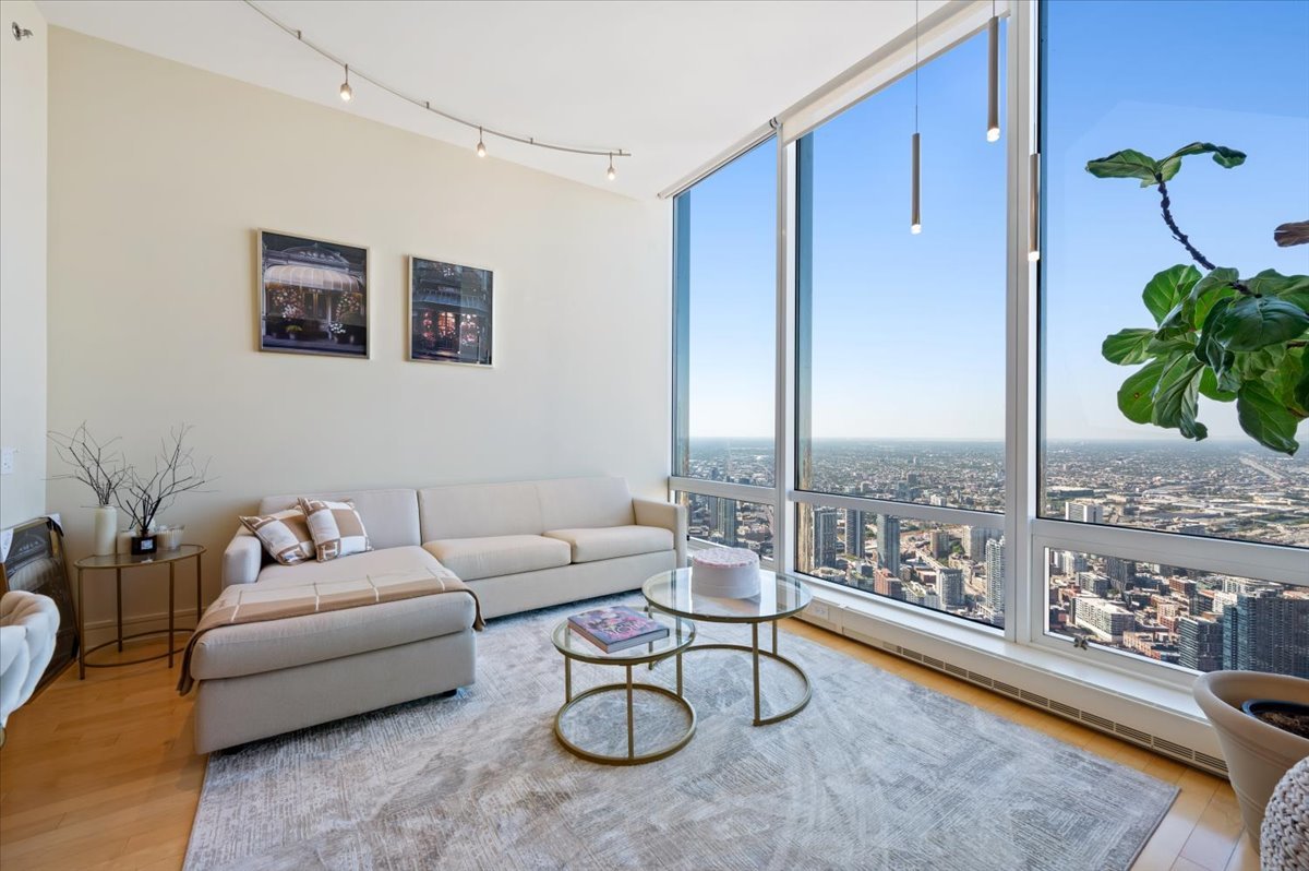 401 North Wabash Avenue, Unit 71C Chicago, IL 60611 - Photo 3 of 38 a living room with furniture potted plant and a large window